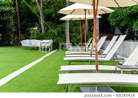 Image of Chaise longue at the pool in tropical resort Image of Chaise longue at the pool in tropical resort 69293439