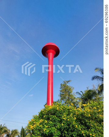 red thai water tower tank with blue sky. Vertical photo. red thai water tower tank with blue sky. Vertical photo. 69296386