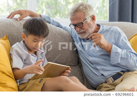 Grandfather and little cute grandson playing Grandfather and little cute grandson playing 69296601