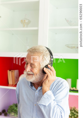 Senior retirement man listen to music using 69296603