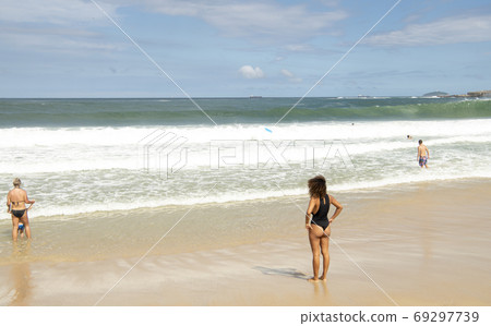 Rio de Janeiro, Brasil- February 28, 2020: Citizens swim and sunbathe on the beach of Copacabana Rio de Janeiro, Brasil- February 28, 2020: Citizens swim and sunbathe on the beach of Copacabana 69297739