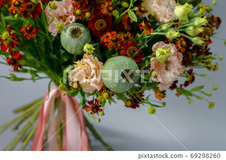 Beautiful summer bouquet in bright colors, gray backdrop, selective focus Beautiful summer bouquet in bright colors, gray backdrop, selective focus 69298260