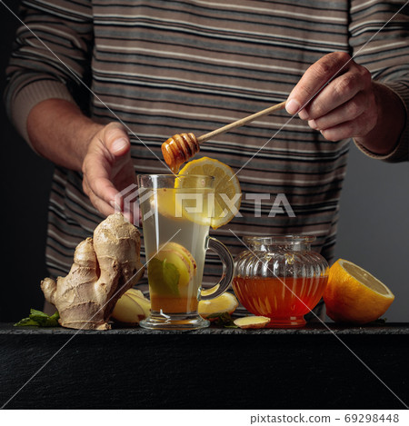 Ginger tea with lemon, mint and honey. 69298448