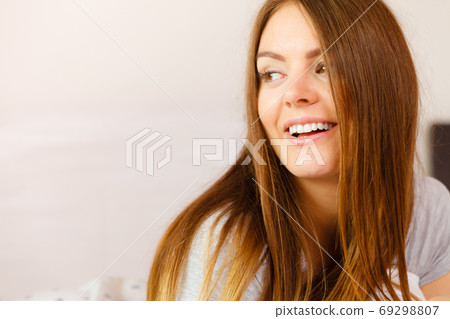 Beautiful woman lying on the bed. 69298807