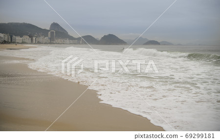 Rio de Janeiro, Brasil- February 28, 2020: Citizens swim and sunbathe on the beach of Copacabana Rio de Janeiro, Brasil- February 28, 2020: Citizens swim and sunbathe on the beach of Copacabana 69299181
