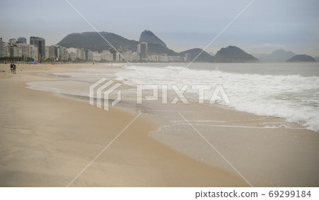 Rio de Janeiro, Brasil- February 28, 2020: Citizens swim and sunbathe on the beach of Copacabana Rio de Janeiro, Brasil- February 28, 2020: Citizens swim and sunbathe on the beach of Copacabana 69299184