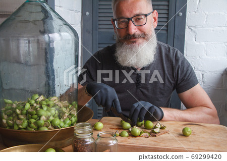 Step-by-step recipe for preparing Italian liquor nocino from green walnuts at home, selective focus Step-by-step recipe for preparing Italian liquor nocino from green walnuts at home, selective focus 69299420