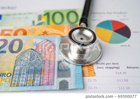 Stethoscope and Euro banknotes on chart or graph paper, Financia 69300077