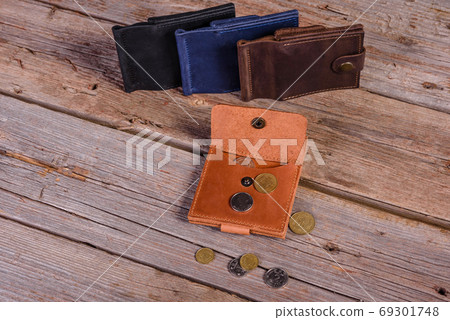 Hand made leather man wallet on wooden background Hand made leather man wallet on wooden background 69301748