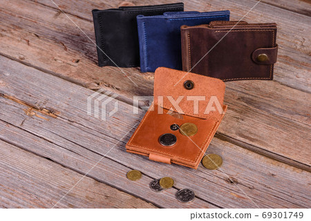Hand made leather man wallet on wooden background 69301749