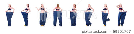 Woman with large jeans in dieting concept Woman with large jeans in dieting concept 69301767