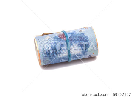 Swiss francs in a roll on white background Swiss francs in a roll on white background 69302107