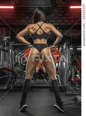 fitness girl exercising with barbell in gym 69302287