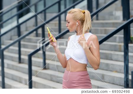 Fitness girl training with favorite playlist, healthy lifestyle Fitness girl training with favorite playlist, healthy lifestyle 69302498