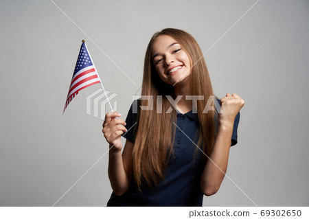 Happy female holding USA flag Happy female holding USA flag 69302650