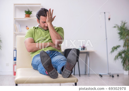 Young man waiting for doctor in the clinic Young man waiting for doctor in the clinic 69302978
