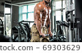 Attractive tall muscular bodybuilder doing heavy deadlifts in moder fitness center. 69303629