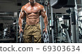 Attractive tall muscular bodybuilder doing heavy deadlifts in moder fitness center. 69303634