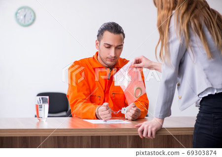 Young man meeting with advocate in pre-trial detention 69303874