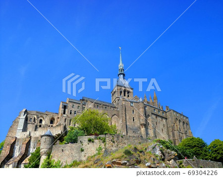 Looking up at Mont Saint Michel in the blue sky Looking up at Mont Saint Michel in the blue sky 69304226