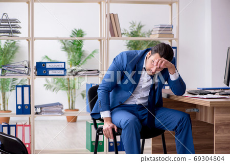 Young male employee businessman at workplace 69304804
