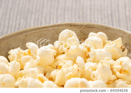 Up of popcorn on a plate. Up of popcorn on a plate. 69304836
