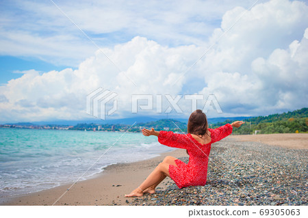 Young beautiful woman relax on the beach Young beautiful woman relax on the beach 69305063