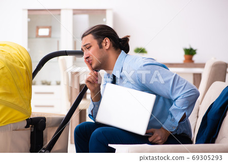 Young businessman looking after newborn at home 69305293