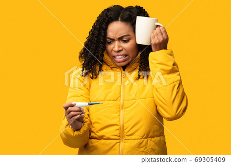 Sick African Girl Holding Thermometer Measuring Temperature, Studio Shot 69305409