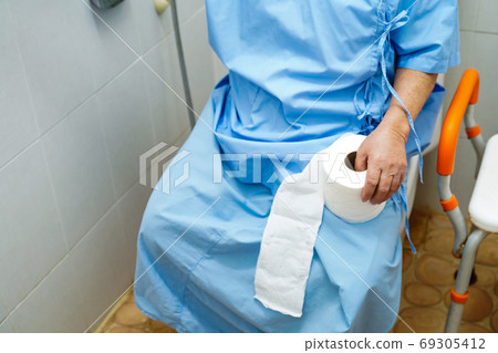 Asian senior elderly old lady woman patient in toilet bathroom with tissue in nursing hospital ward Asian senior elderly old lady woman patient in toilet bathroom with tissue in nursing hospital ward 69305412