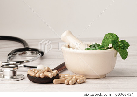 Stethoscope with medicine herbal capsule, vitamin, mineral for healthy good life. Stethoscope with medicine herbal capsule, vitamin, mineral for healthy good life. 69305454