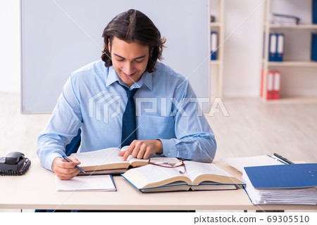Young businessman student studying at workplace 69305510