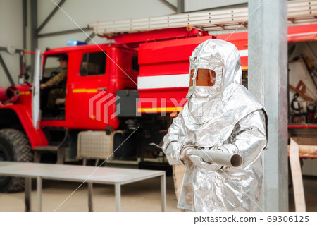 Fireman in a special foil protective suit Fireman in a special foil protective suit 69306125