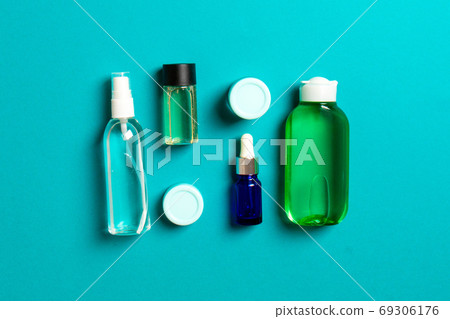 Cosmetics SPA branding mock-up, top view with copy space. set of tubes and jars of cream flat lay on colored background Cosmetics SPA branding mock-up, top view with copy space. set of tubes and jars of cream flat lay on colored background 69306176