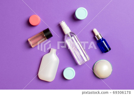 Cosmetics SPA branding mock-up, top view with copy space. set of tubes and jars of cream flat lay on colored background Cosmetics SPA branding mock-up, top view with copy space. set of tubes and jars of cream flat lay on colored background 69306178
