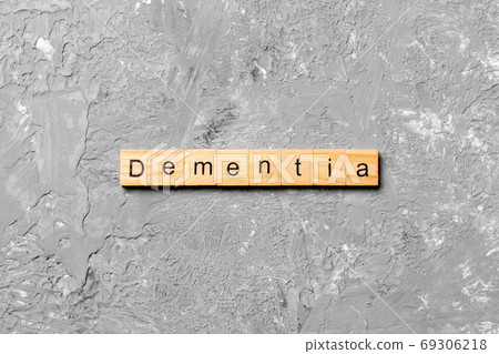 Dementia word written on wood block. Dementia text on cement table for your desing, concept Dementia word written on wood block. Dementia text on cement table for your desing, concept 69306218