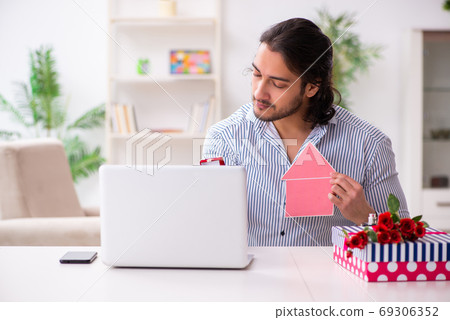 Successful young man doing marriage proposal via internet 69306352