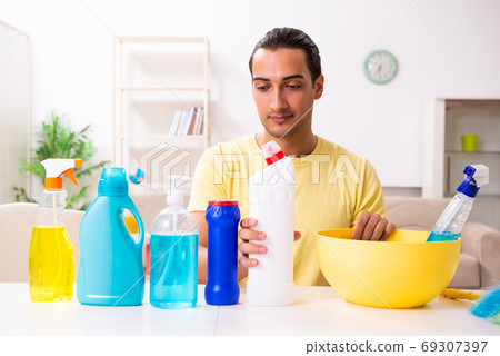 Young male contractor doing housework at home 69307397