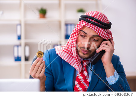 Young male arab employee working in office 69308367