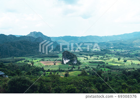 Mountains and green trees during the day Mountains and green trees during the day 69308376