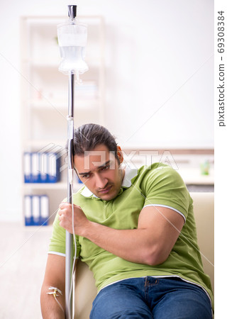 Young male patient in blood transfusion concept Young male patient in blood transfusion concept 69308384