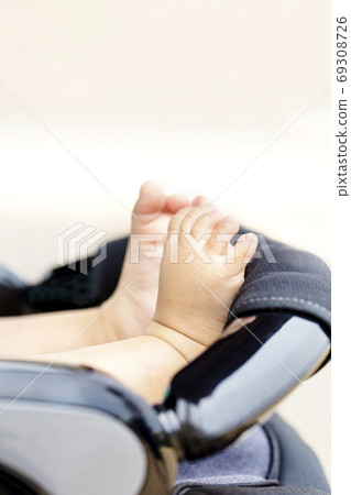 Child seat and baby feet and copy space 69308726