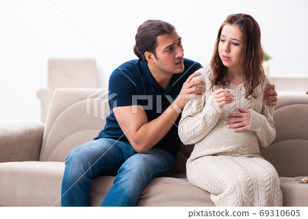 Man and pregnant woman in antismoking concept Man and pregnant woman in antismoking concept 69310605