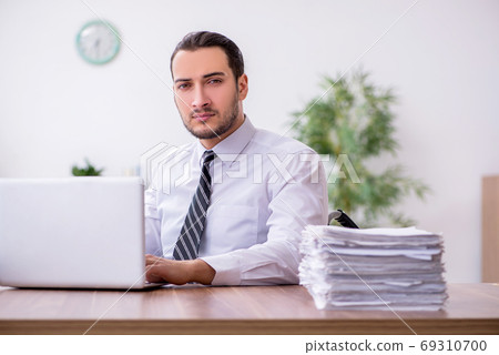 Young disabled employee suffering at workplace Young disabled employee suffering at workplace 69310700