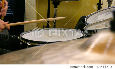 Playing drums on drum kit Playing drums on drum kit 69311303