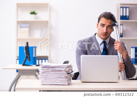 Leg injured employee in the office Leg injured employee in the office 69312322