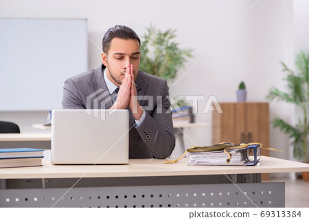 Young male employee with snake in the office Young male employee with snake in the office 69313384