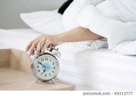 A Man Hand Try to Stop the Alarm of the Clock in the Morning 69313777