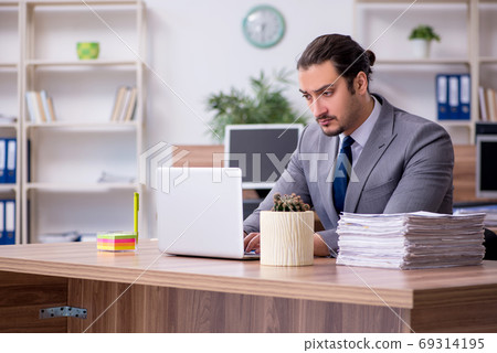 Young male employee working in the office 69314195