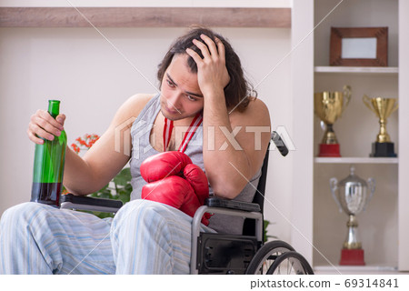 Male ex-champion boxer in wheel-chair suffering from alcoholism 69314841